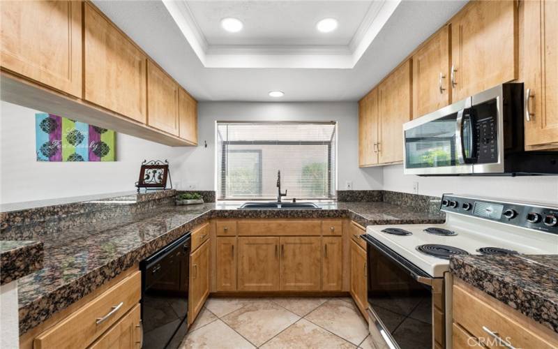 Kitchen has newer cabinets, recessed lights and lots of natural lighting.