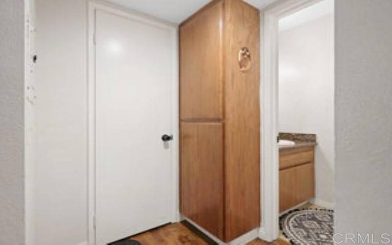 Hall Closet leading to Downstairs Half-Bathroom