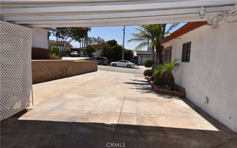 long drive way for plenty of parking with additional patio infront of garage