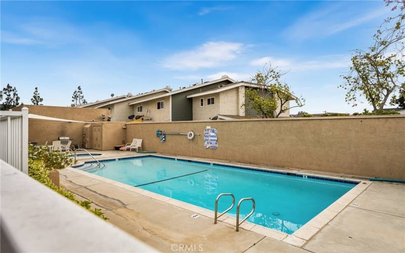 Community pool and spa with bar b-q and lounging.