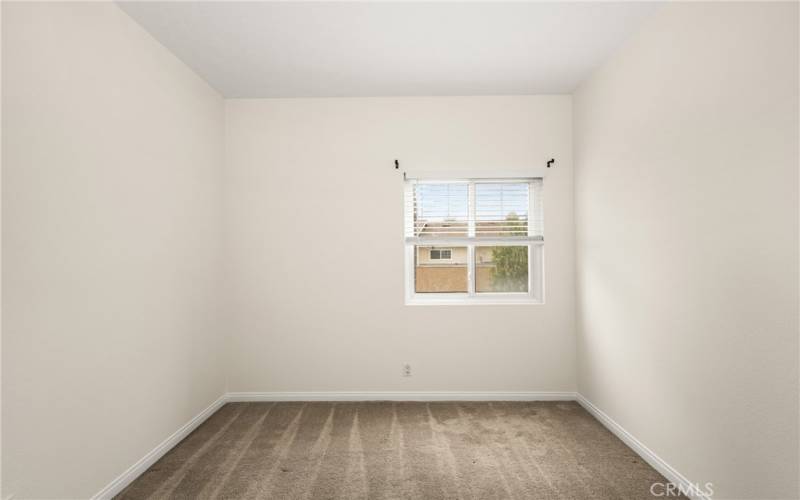 Another secondary bedroom with higher ceilings and two built in closets.