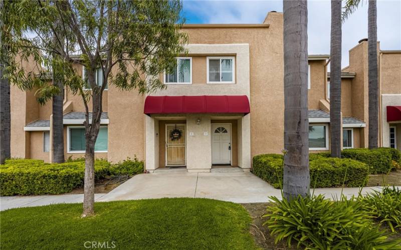 Beautiful entry with protective awning that highlights the home.