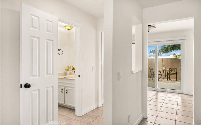 Half Bath in the hallway with door sliders to outside patio.