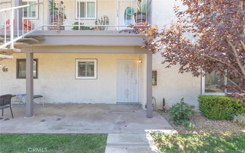 Charming ground-level entrance with a cozy patio space.