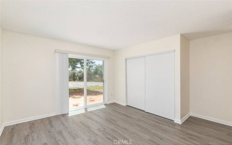 Cozy bedroom featuring sliding glass doors and abundant natural light.