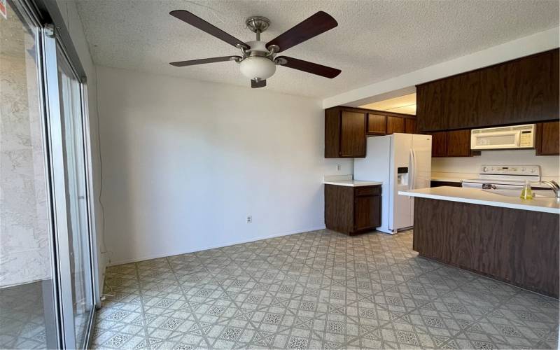 The dinning room is adjacent to the kitchen. The sliding patio door leads to the courtyard.