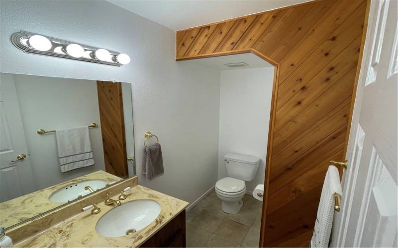 The downstairs 1/2 bath is conveniently tucked under the stairwell.