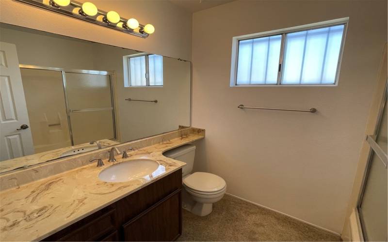 This upstairs bathroom has a shower tub combo.