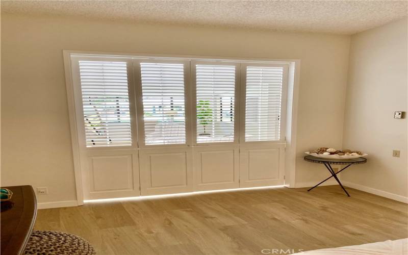 2nd bedroom with shutter doors closed, louvers partway open