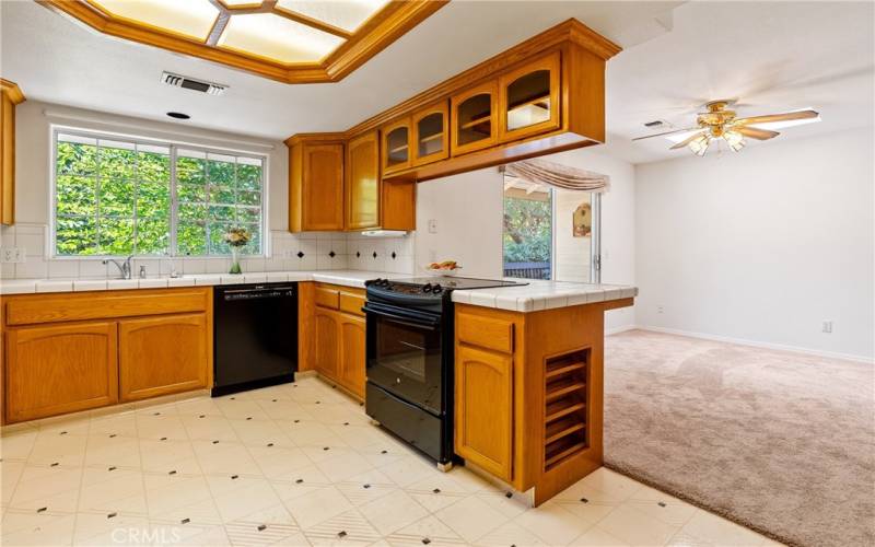 Spacious kitchen with electric stove and dishwasher