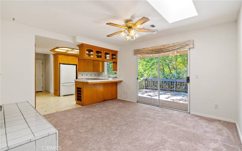 Kitchen open to dining area with access to back deck