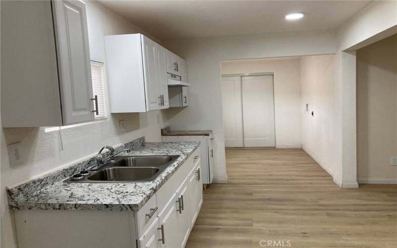 Back unit - Kitchen other view.  Looking through the laundra area towards front door