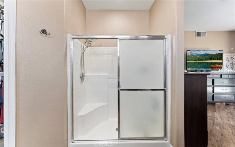 Primary Ensuite Bathroom with walk-in shower and walk-in closet