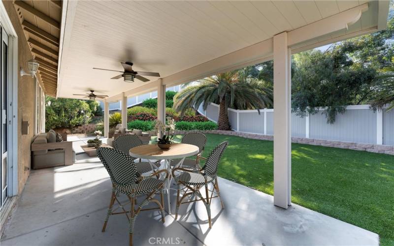 Alumawood patio cover runs length of home. Disclaimer: Left corner hillside of yard has been virtually landscaped to highlight potential