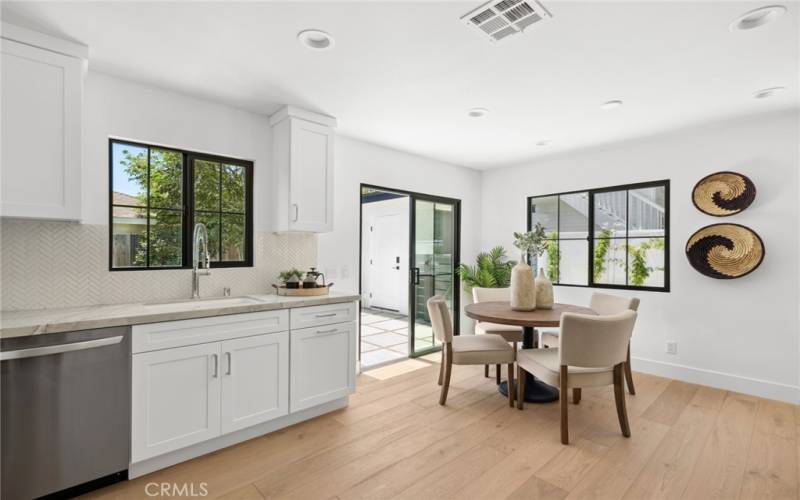  Back house kitchen and dining looks out on and opens to rear patio and lawn area