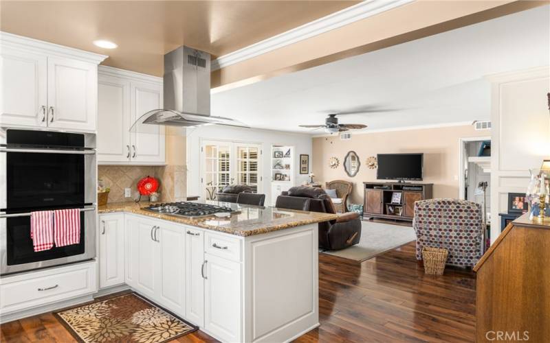 Kitchen with island and overhang for bar stoos.