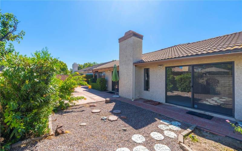 Landscaped Yard off of Living Room and Primary Suite