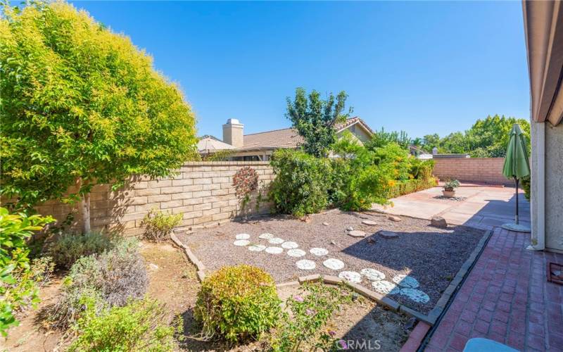 Landscaped Yard off of Living Room and Primary Suite