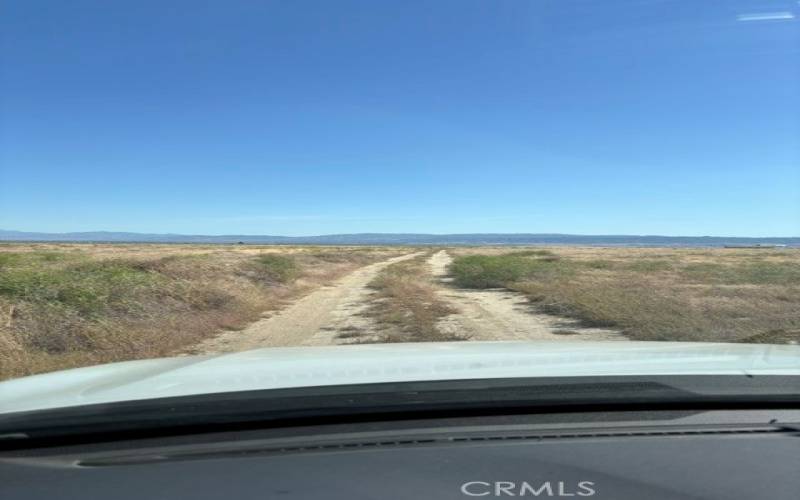 Dirt road that can be driven on going North from Avenue D up to C-4 and the Northern Border of the property where the Telephone Poles-Electrical poles are located.