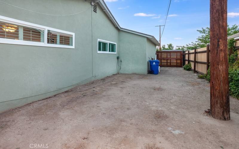 The private backyard will be a favorite entertainment destination with its large covered patio, sprawling green lawn, mature shade/citrus tree and generous side yard that is perfect for a garden or dog run.