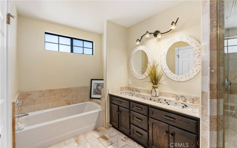 Primary bathroom has very unique sink and separate tub and shower.