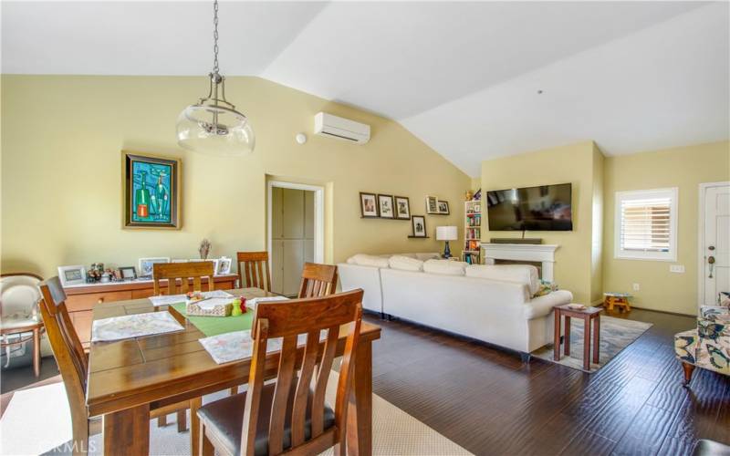 Dining area leading into primary bedroom and living room. Also included is split AC unit to keep home cool during the hot and humid summer months.