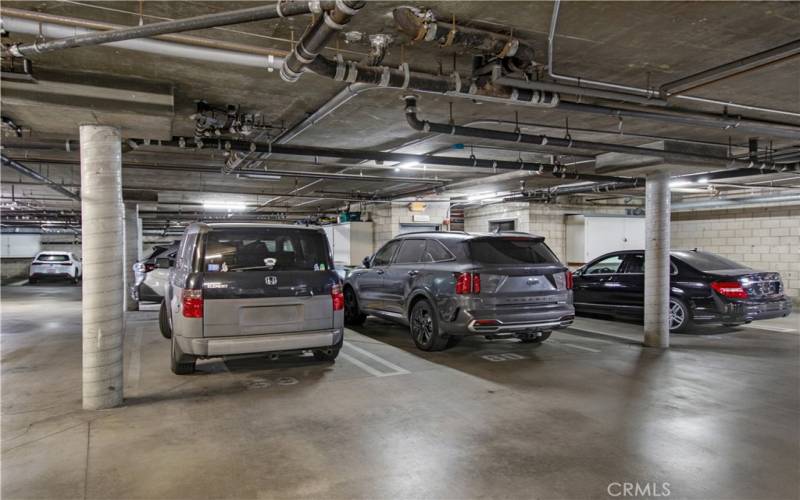 Subterranean garage including two assigned spaces conveniently located next to elevator.