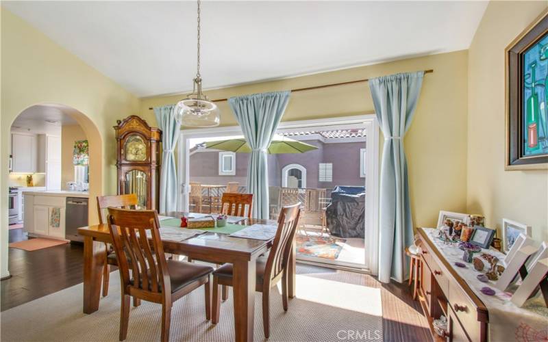 Dining room area leading into kitchen and back patio.