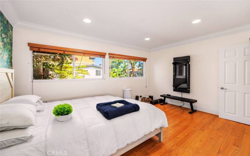 A beautiful large bedroom with an abundance of natural light