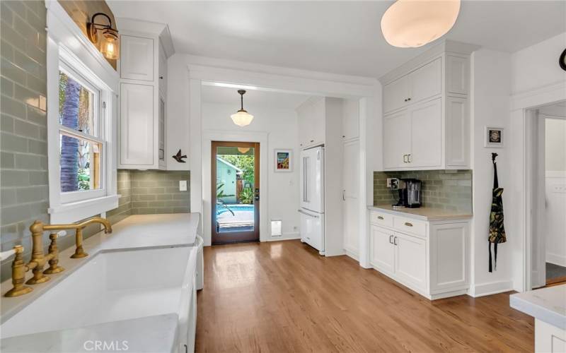 Alternate view of remodeled kitchen with back door to resort-like backyard!