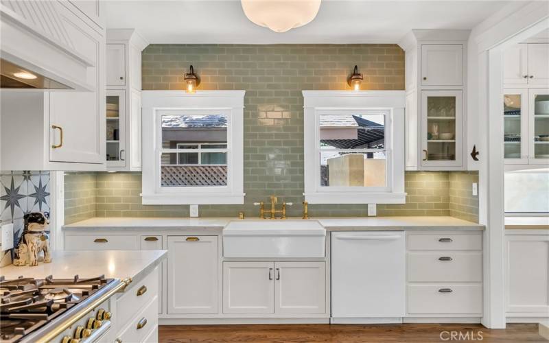 Remodeled kitchen with white carrera quartz counter tops, dishwasher, farm sink, and all new custom cabinetry.