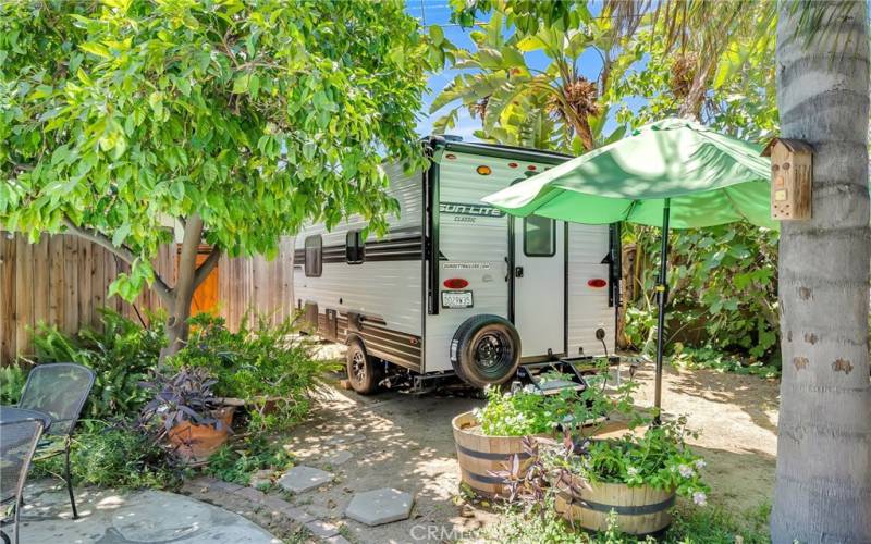 Citrus and palm trees dot the landscaping in the far back yard that currently houses a small RV, but could accommodate an ADU if needed.