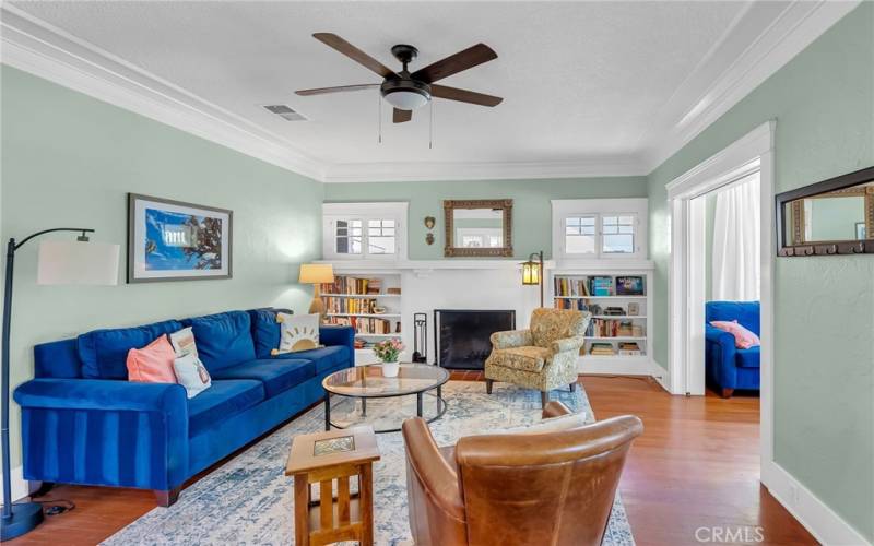 As you walk through the front door and turn right, this is the living room with wood-burning fireplace, with a peekaboo view into the den (which could also be the 3rd bedroom) with solid wood privacy pocket doors.