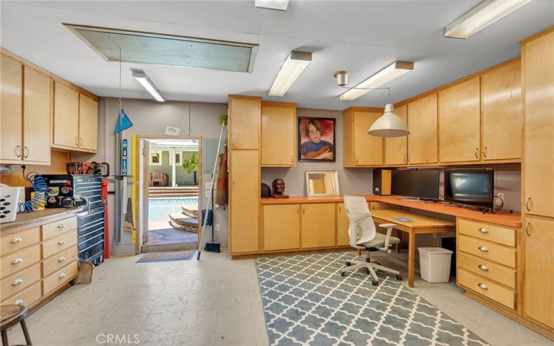 The garage with newer roof was turned into a workshop with custom cabinetry.