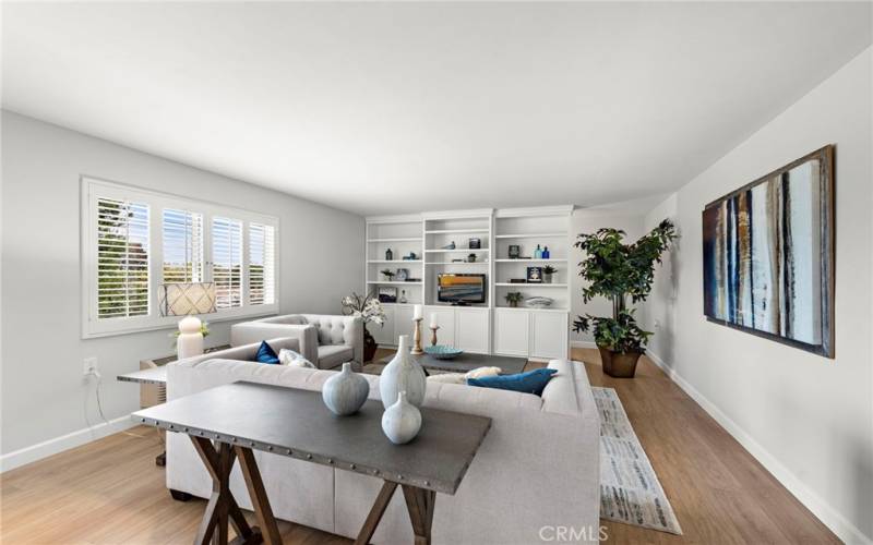 The living room features luxury laminate plank flooring, fresh designer paint, smooth ceilings, and plantation shutters.