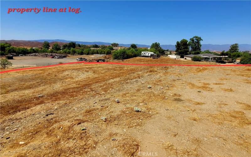 Property line along the back of lot in red. *large Log runs in approximate line with property.