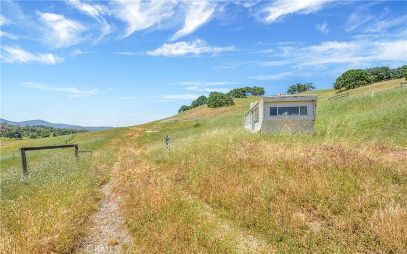 Property includes a project trailer near the greenhouse structures