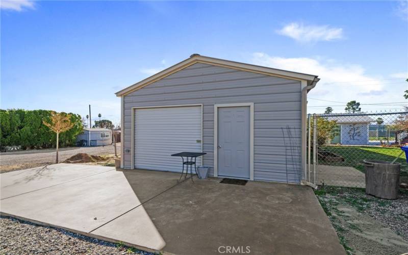 Front of Barn with roll up door and man door