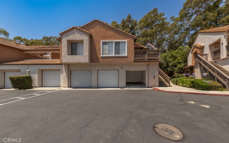 The garage is on the far right below the home