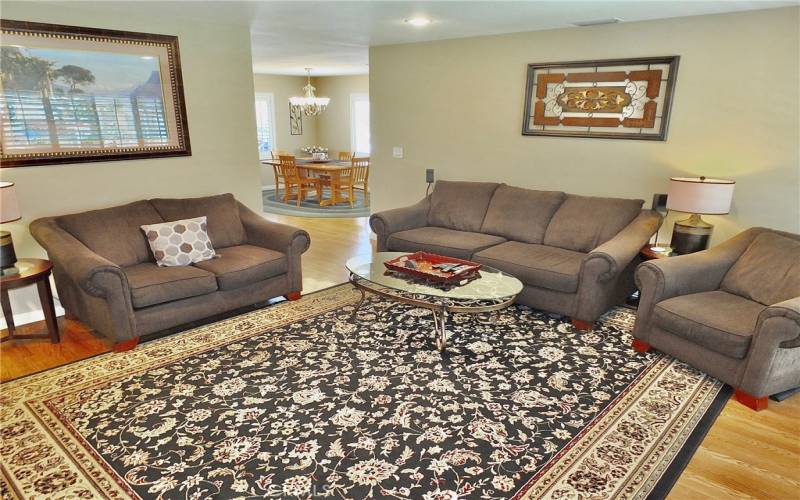 View from living room with recessed lighting that is looking into dining room.