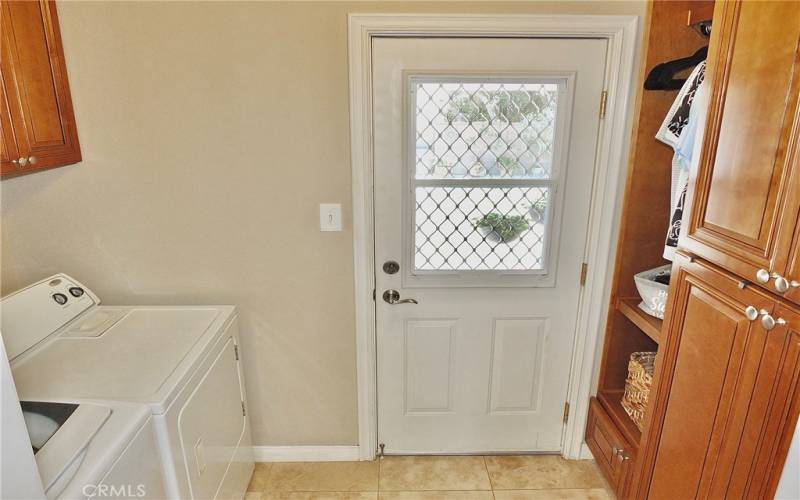 This remodeled inside laundry room combines beauty and functionality, featuring a built-in pantry for convenient storage and efficient organization.