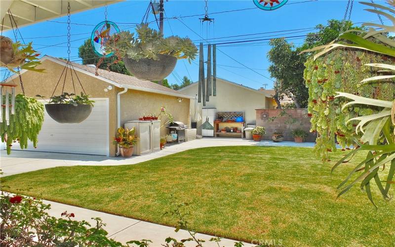 Another view of the beautiful backyard and 2 car garage