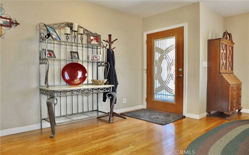 A stunning wood door with leaded glass adds charm to the entrance of this lovely home.