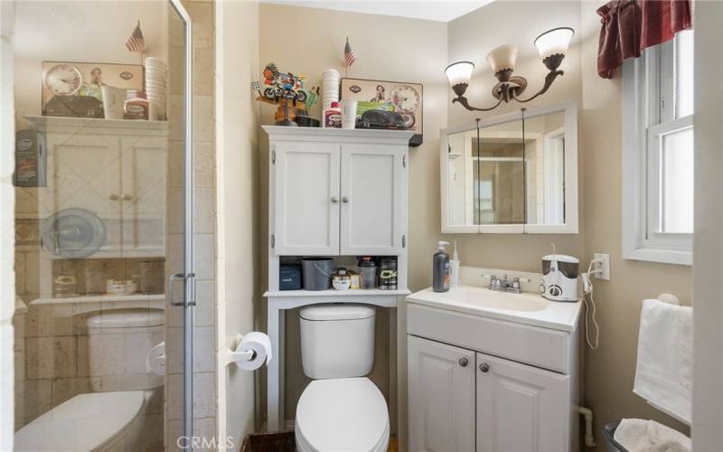 Primary bath with a Travertine shower stall.