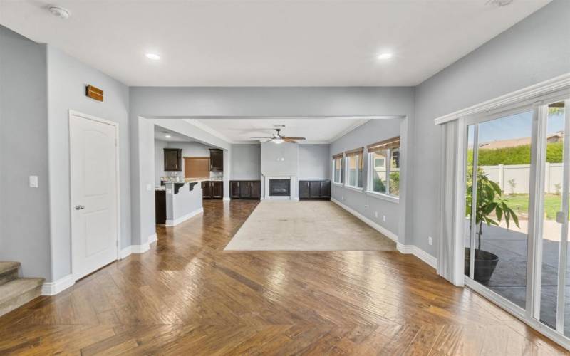 View of Formal Dining Room, Living Room w/Fireplace as well as Pantry and Kitchen to the Left