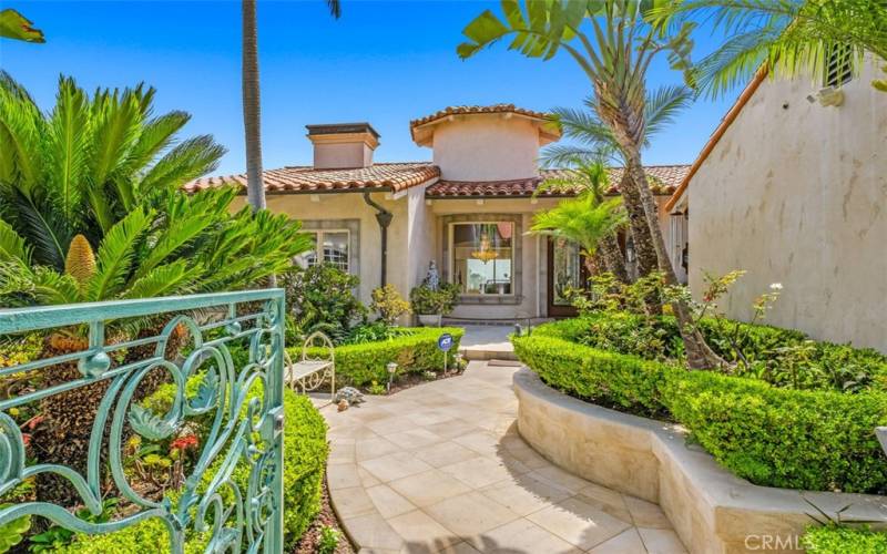 Entry private gated courtyard leading to custom double entry doors.