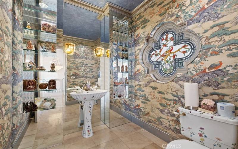 One of two beautifully designed powder rooms, this one features Sheryl Wagner fixures & custom designed stained glass window.