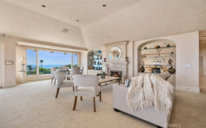 Relax and enjoy in amazing great room with high ceilings, fireplace and huge windows to show off Blue Pacific.