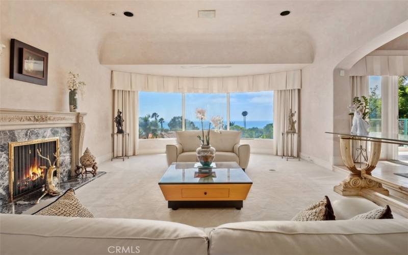 Living room with gorgeous fireplace and stunning ocean views, first ocean views as you enter.