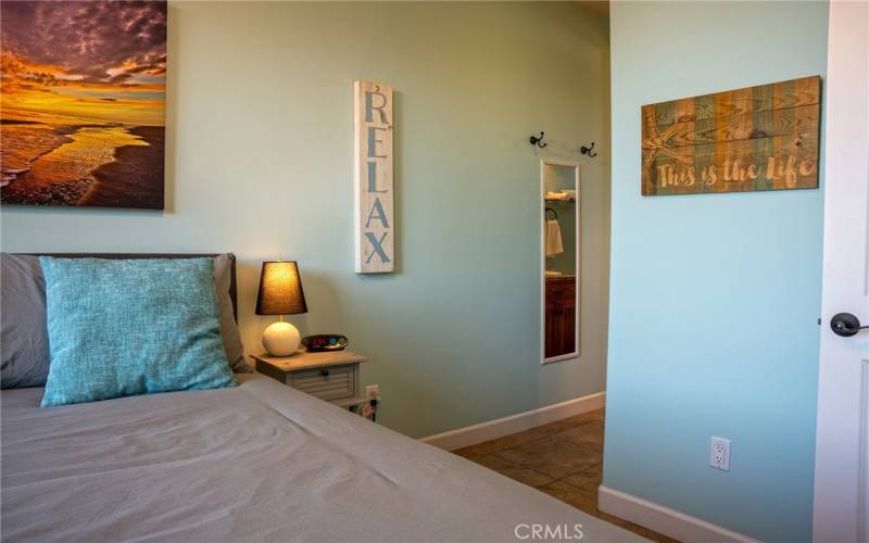 View of hallway to walk in closet and bathroom